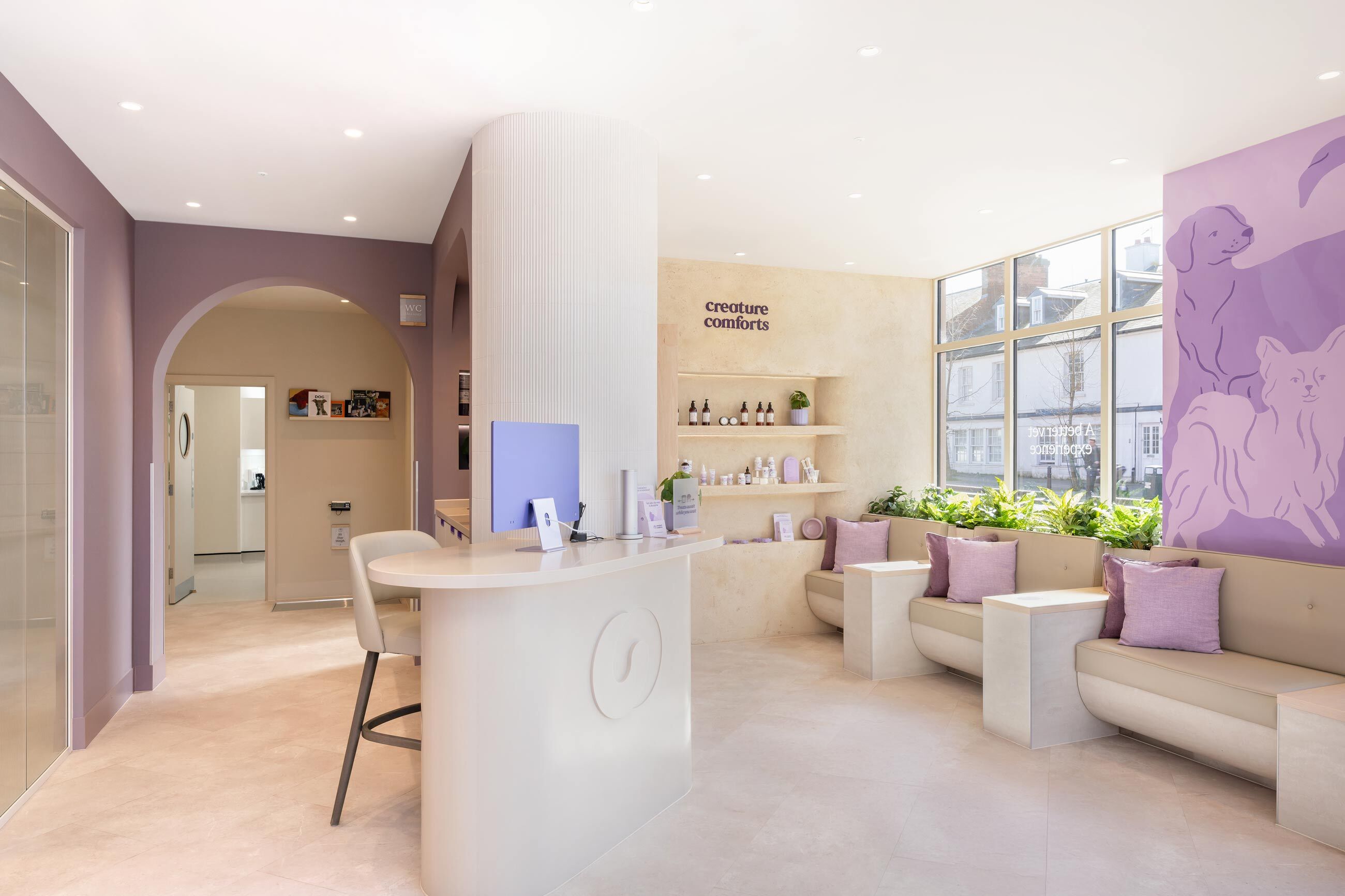 Bright and inviting animal clinic reception with modern decor, welcoming seating, and a display of pet care products.
